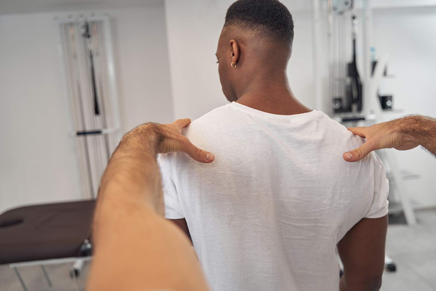 Man undergoing spine exam in standing posture
